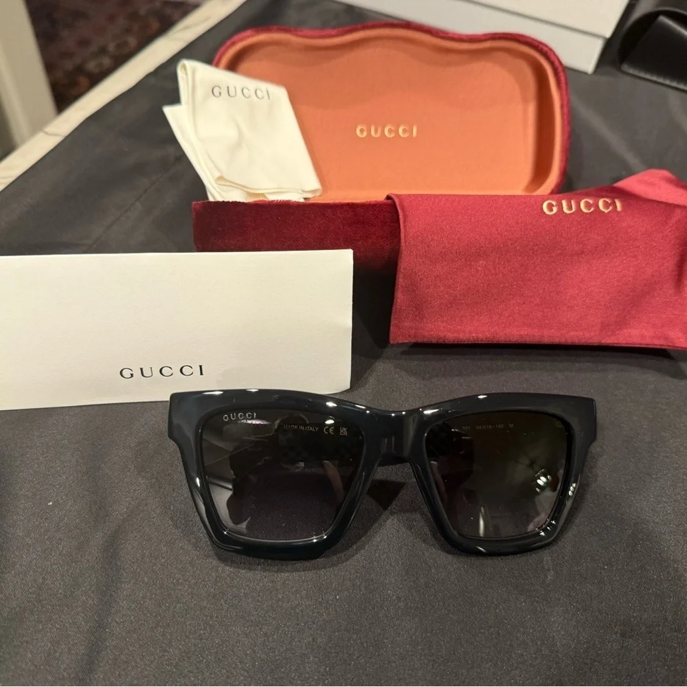 Gucci GG1714S cat-eye sunglasses with a black frame and solid grey lenses